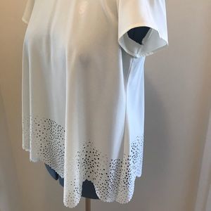 Cream colored blouse with a scallop cut